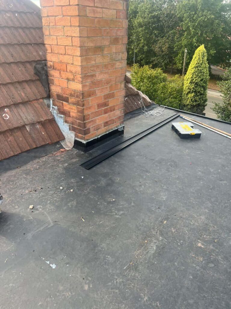 This is a photo of a flat roof which has just been repaired, there is also a chimney stack and some leadwork has also been dressed. Works carried out by LS Roofing Beaconsfield